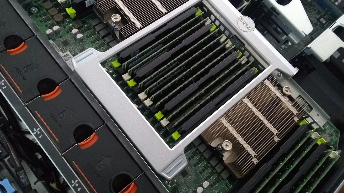 Rows of computer RAM modules inside a server rack.