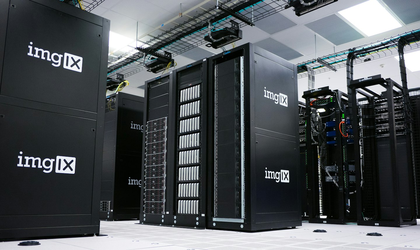 Rows of server racks inside a brightly lit data center.